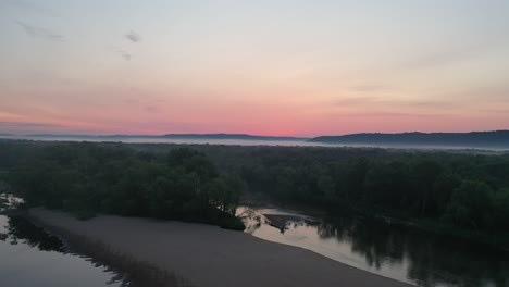 sunrise over a misty river valley
