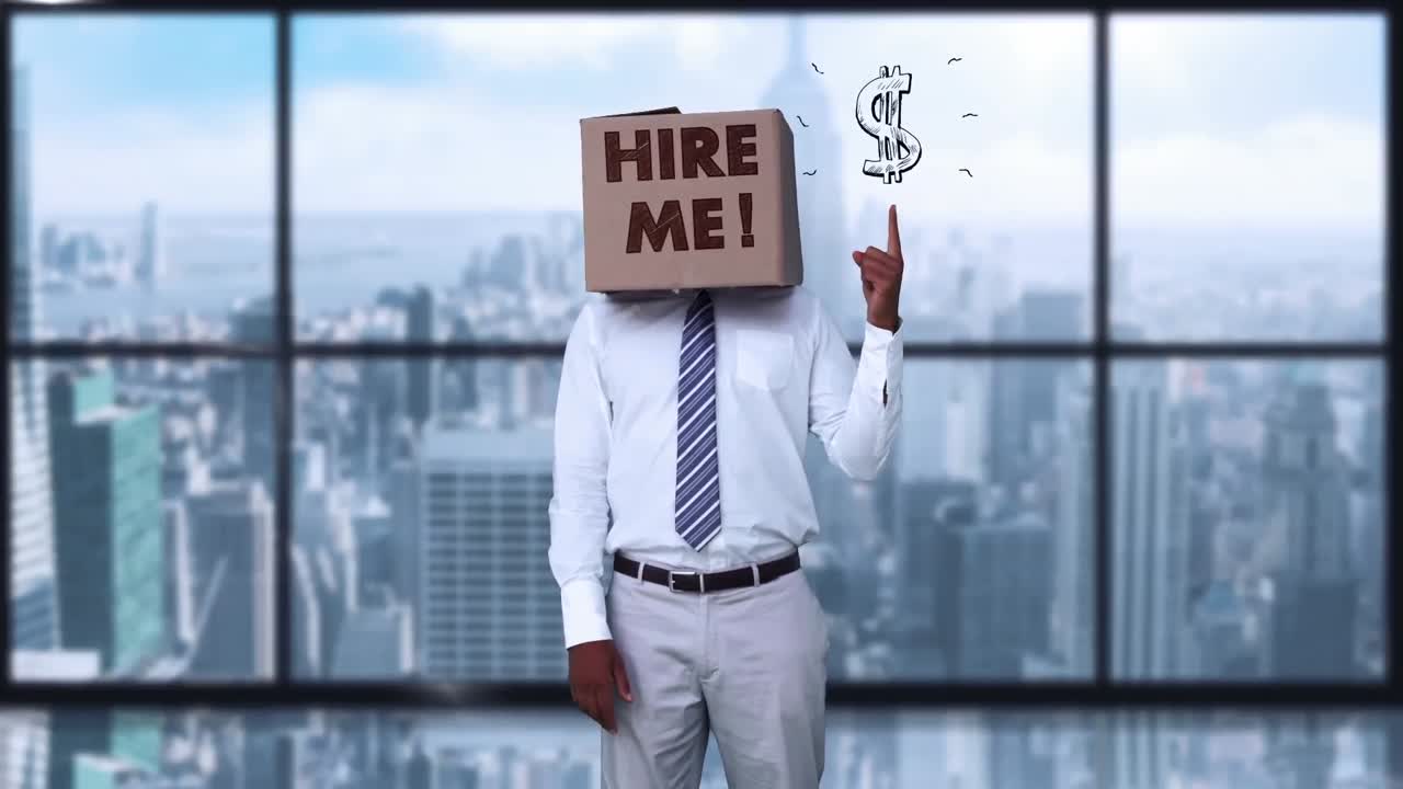Businessman wearing hire me box and pointing on dollar sign