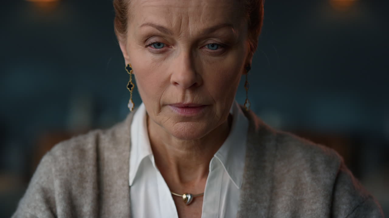 Happy old woman receiving good news by email in luxury cabinet