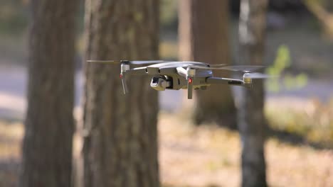 drone copter flying with digital camera in forest