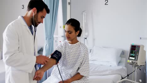 Doctor-checking-blood-pressure-of-a-female-patient