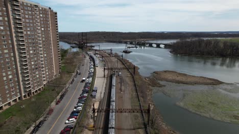 An-aerial-view-of-a-train-traveling-in-the-Bronx-in-New-York-towards-the-Pelham-Bay-Railroad-Bridge-on-a-sunny-morning