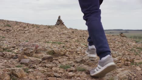 person walking on a rocky trail