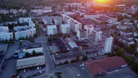 Setting-sun-adds-warmth-to-aerial-flyover-of-city-high-rise-buildings