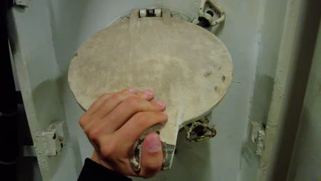 view of a closed metal ship porthole from inside