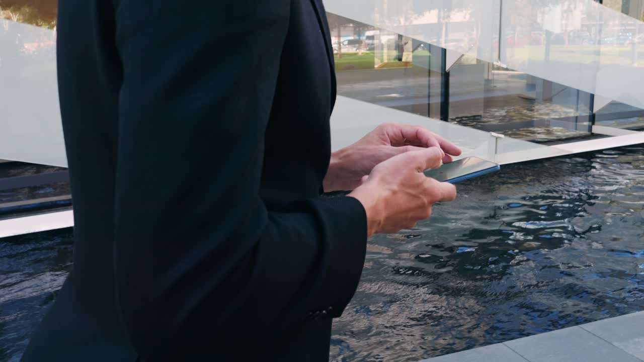Man using smartphone near modern building