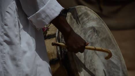 berbere musician playing tradicional drum in the sahara desert, marocco