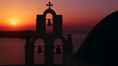 an amazing and beautiful sunset behind a greek orthodox church on the greek island of santorini 3