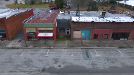 drone shot of a rundown abandoned small town main street