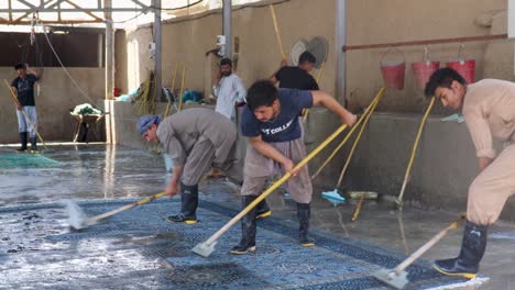 sweepers cleaning rugs up close