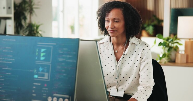 Professional Woman Working on Computer Code in Modern Office