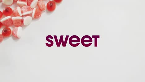 Animation-of-halloween-sweet-text-over-sweets-on-grey-background