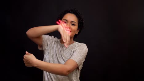 Happy-Young-Woman-Dancing-with-Glowing-Lines.leisure-and-people-concept--happy-african-american-woman-in-glasses-dancing-over-grey-background-with-animated-glowing-neon-lines