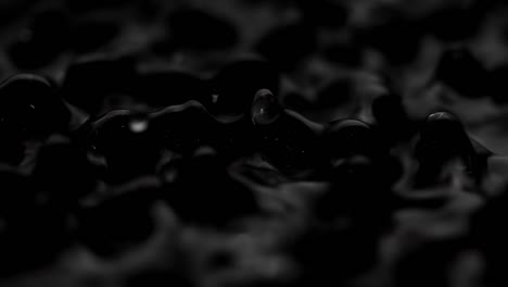 splashes and drops on the surface of the liquid. abstract black background water vibration. 4k slow motion 100 fps, prores 422, 10 bit