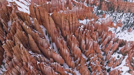 Bryce-National-Park-Red-Canyon-Covered-In-Snow-In-Utah,-United-States---aerial-shot