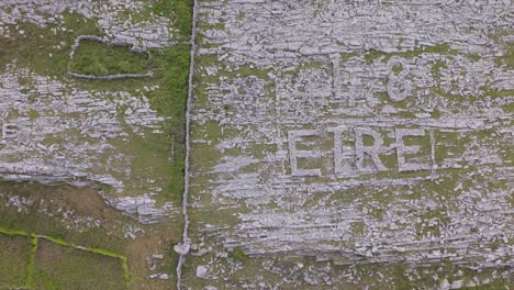 aerial shot of the iconic 'eire 48' sign made of rocks in the burren, ireland