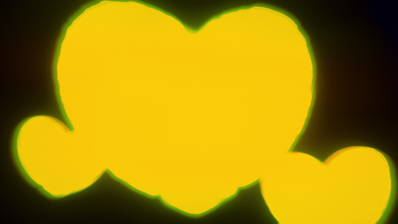 Yellow energy heart shapes on a dark background