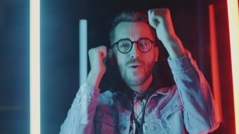 man celebrating with neon lights