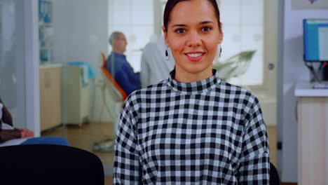 portrait of smiling woman patient looking on webcam