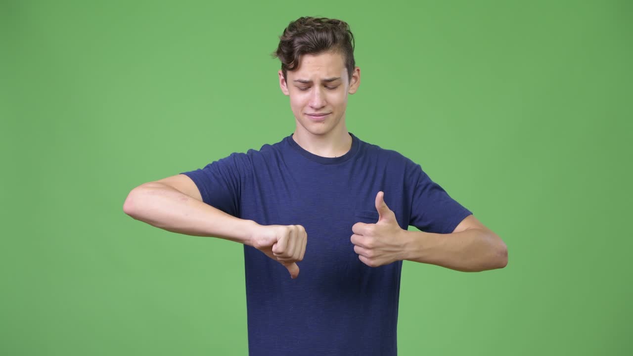 Young handsome teenage boy being indecisive