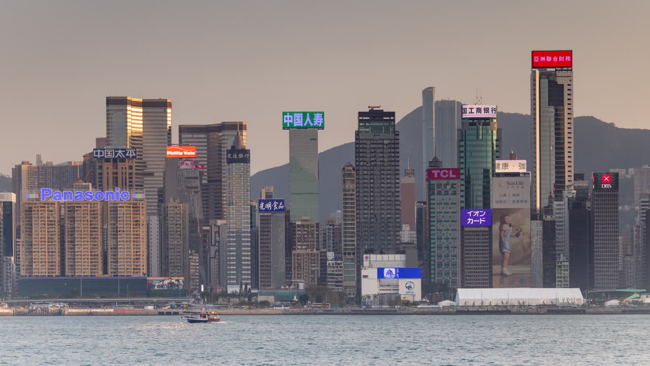 HONG KONG - 19 MARCH 2025 : Hong Kong Central city skyline filmed from across the harbour in kowloon