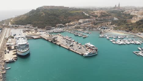 4k aerial drone footage panning right to the city of gozo on the island of malta of the mediterranean sea