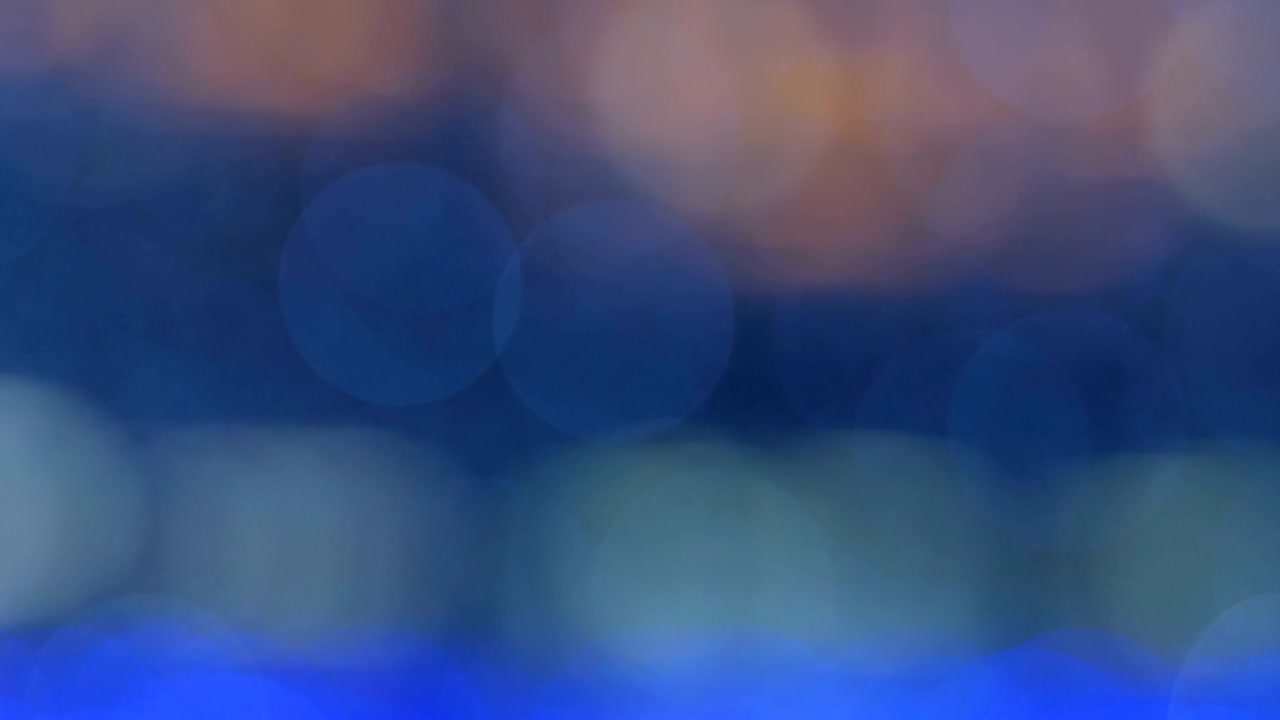 Night abstract background is defocused with nice bokeh. Blurred Christmas Lights Bokeh. Pan across blur .
