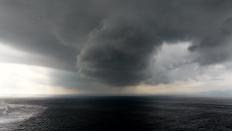 dramatic stormy cumulus clouds over dark sea