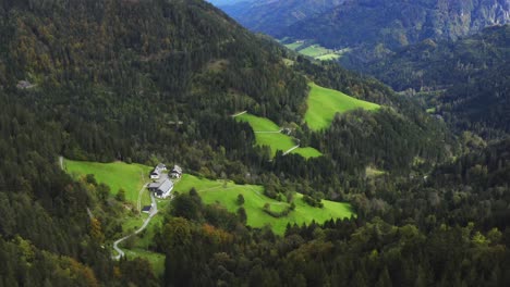 drone view of a house in the mountain valley surrounded by forest