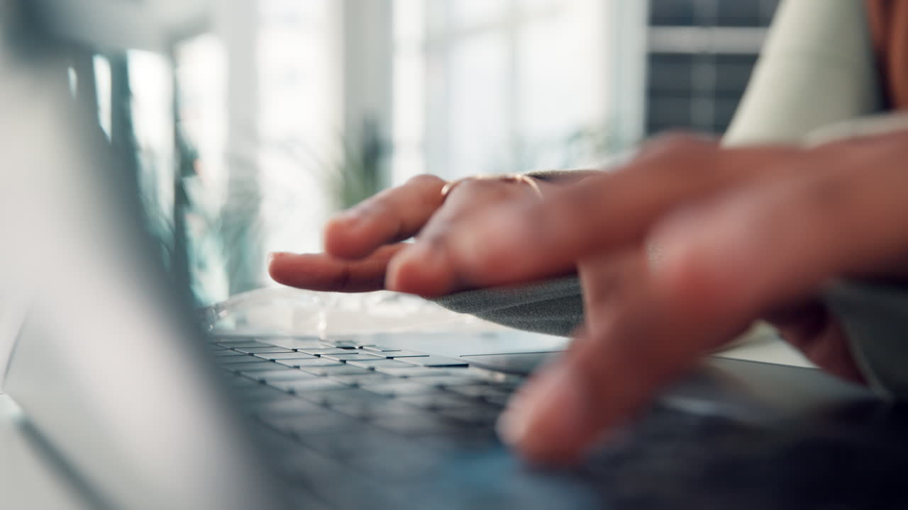 Close-Up of Hands Typing on Laptop Keyboard