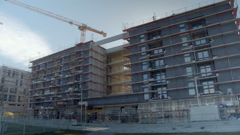 Exterior Of Unfinished Buildings With Tower Cranes In Background