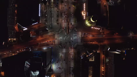 Vista-Aérea-De-Pájaros-Vista-Panorámica-De-Arriba-Hacia-Abajo-De-Los-Automóviles-Que-Comienzan-En-La-Intersección-Con-Luz-Verde.-Tráfico-En-La-Ciudad-De-Noche.-Varsovia,-Polonia