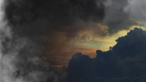 a thunderstorm in the sky with dark and orange clouds