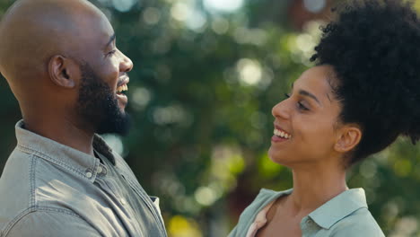 portrait of loving couple standing outdoors in garden park or countryside