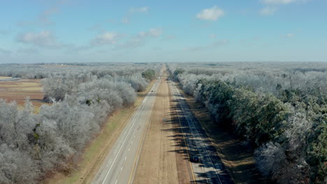 aerial view moving backwards over rural interstate highway road with cars, 4k