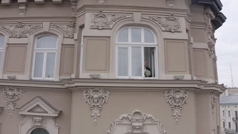 aerial view of stylish groom man stay at window at home gets ready before date or meeting with bride