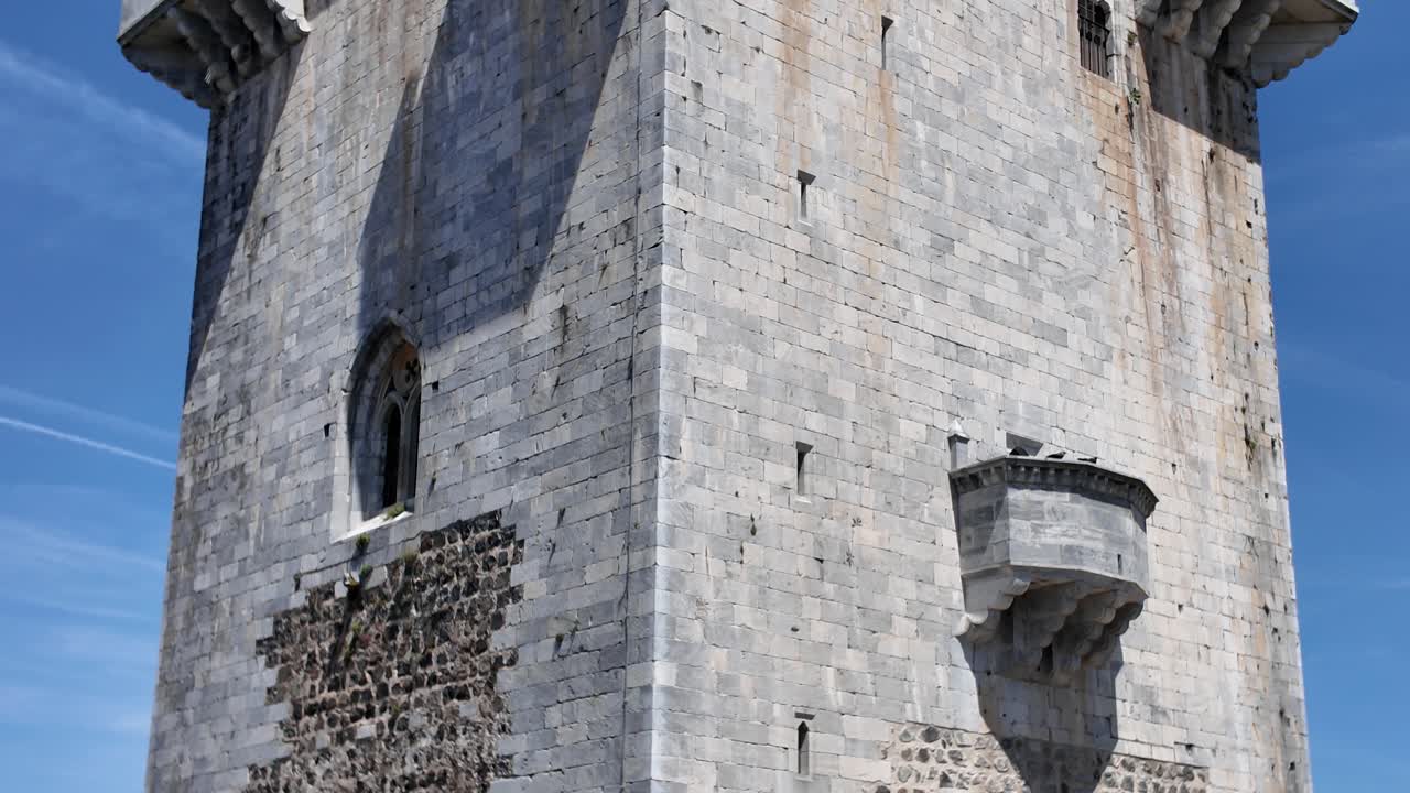 Castle of beja stone tower with battlements against a vibrant blue sky