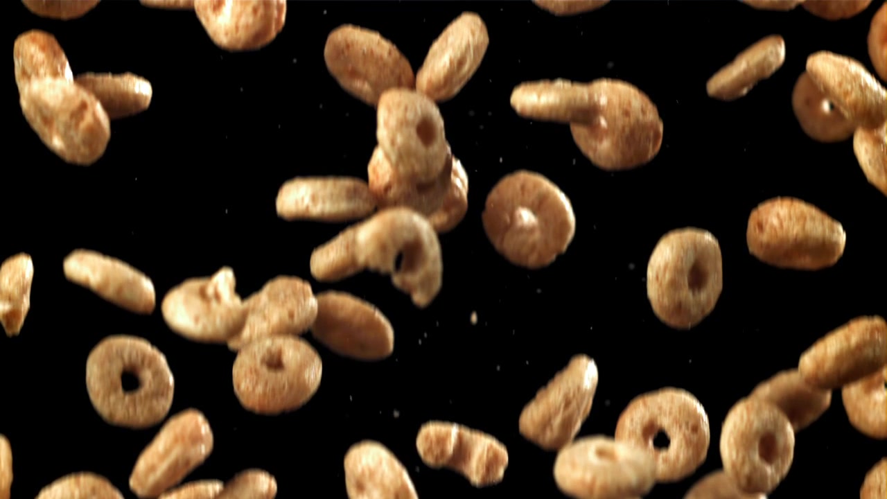 Golden Cereal Rings and Ovals Falling in Slow Motion