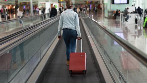 mature african woman wearing safety face mask inside international airport