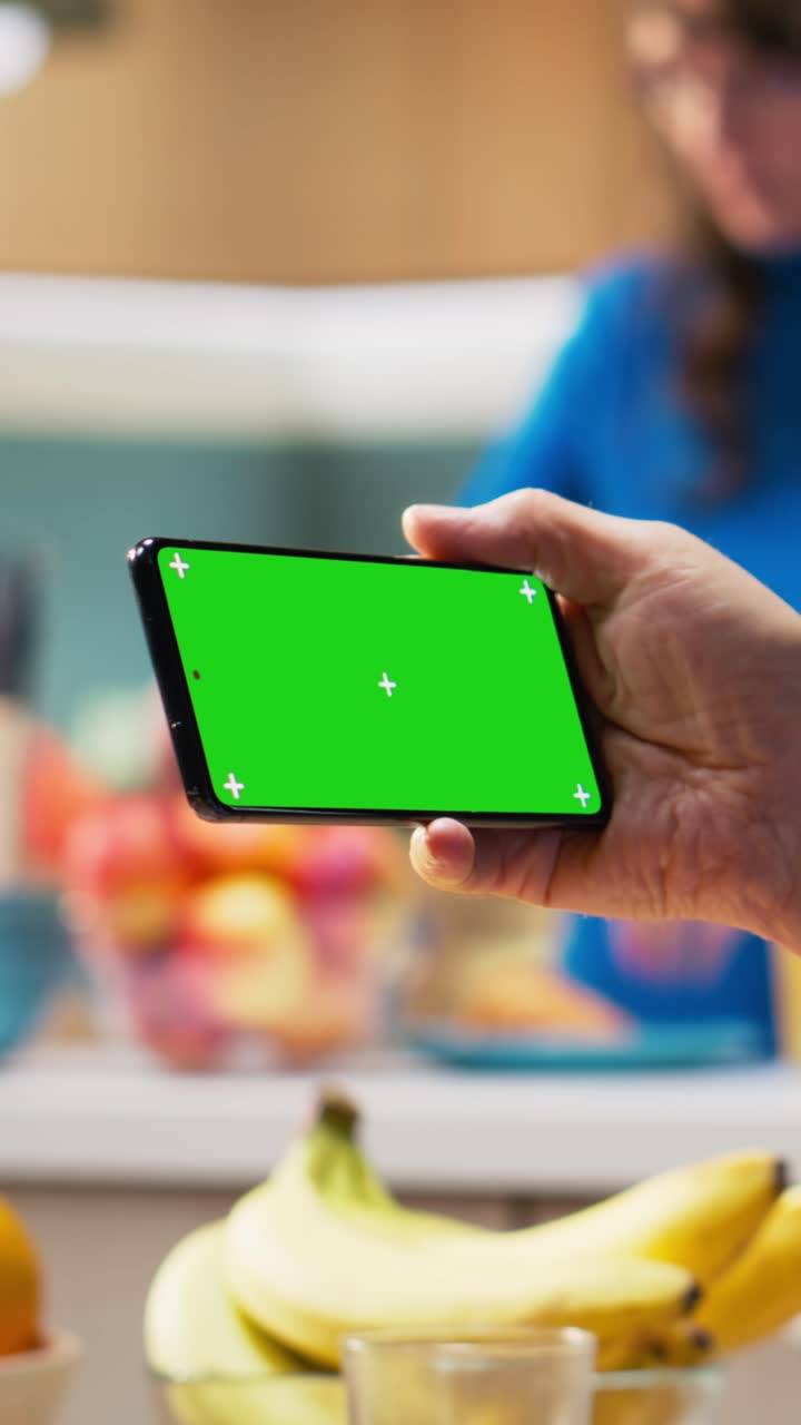 Vertical Video Horizontal chroma key on phone with mature man enjoying retired life at home