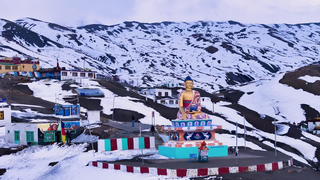 Buddhist Statue in Snowy Mountains