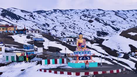buddhist statue in snowy mountains