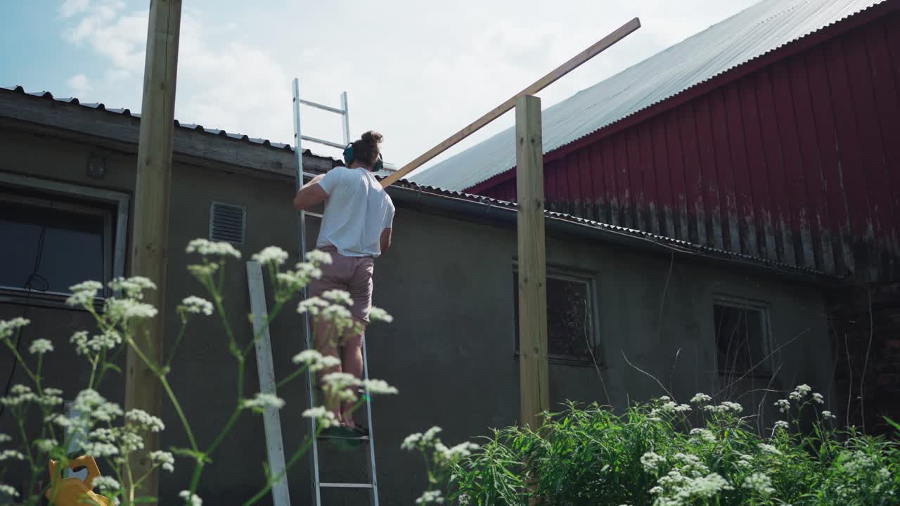 hombre construyendo un invernadero en el patio - ancho