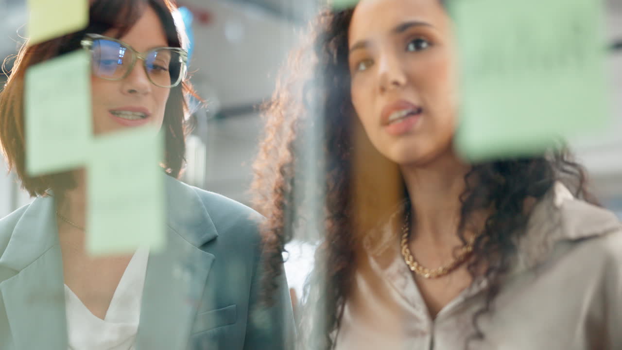 Sticky notes, business women and brainstorming