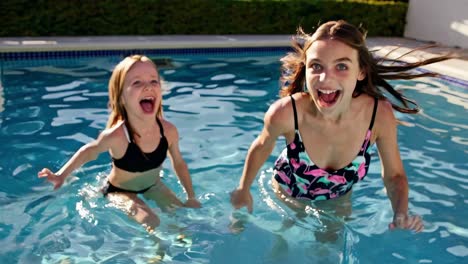 two sisters having fun in a swimming pool