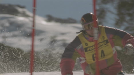 a man skies around a slalom flag