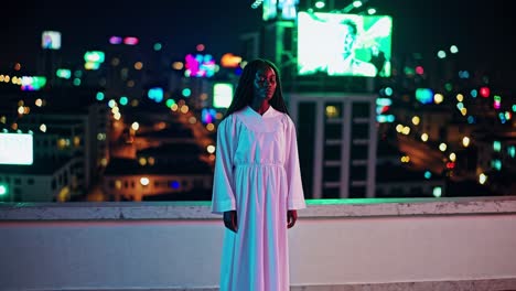 priest stands serenely on a rooftop at night, overlooking a cityscape illuminated by vibrant neon lights and advertisements, creating a striking contrast between spirituality and urban life