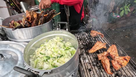 preparing grilled meat and stir-fried vegetables outdoors