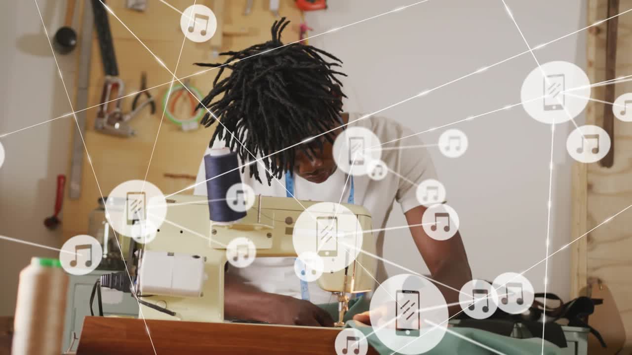 Tailor guiding fabric at machine for fashion, animated network icons fading in overlaying work area