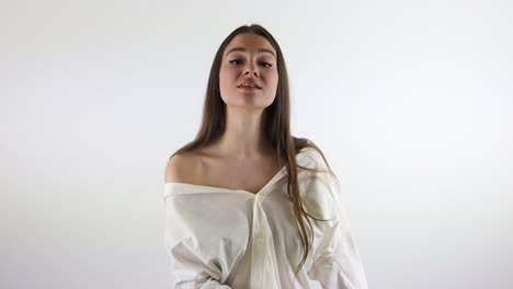 stunning female model moving and singing in front of a white background
